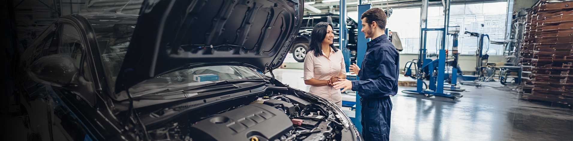 Service advisor and technician reviewing a vehicle in the shop